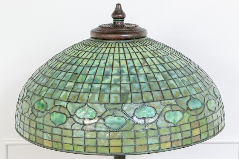 This stunning Tiffany Studios bronze lamp features a glass shade with green acorn patterns